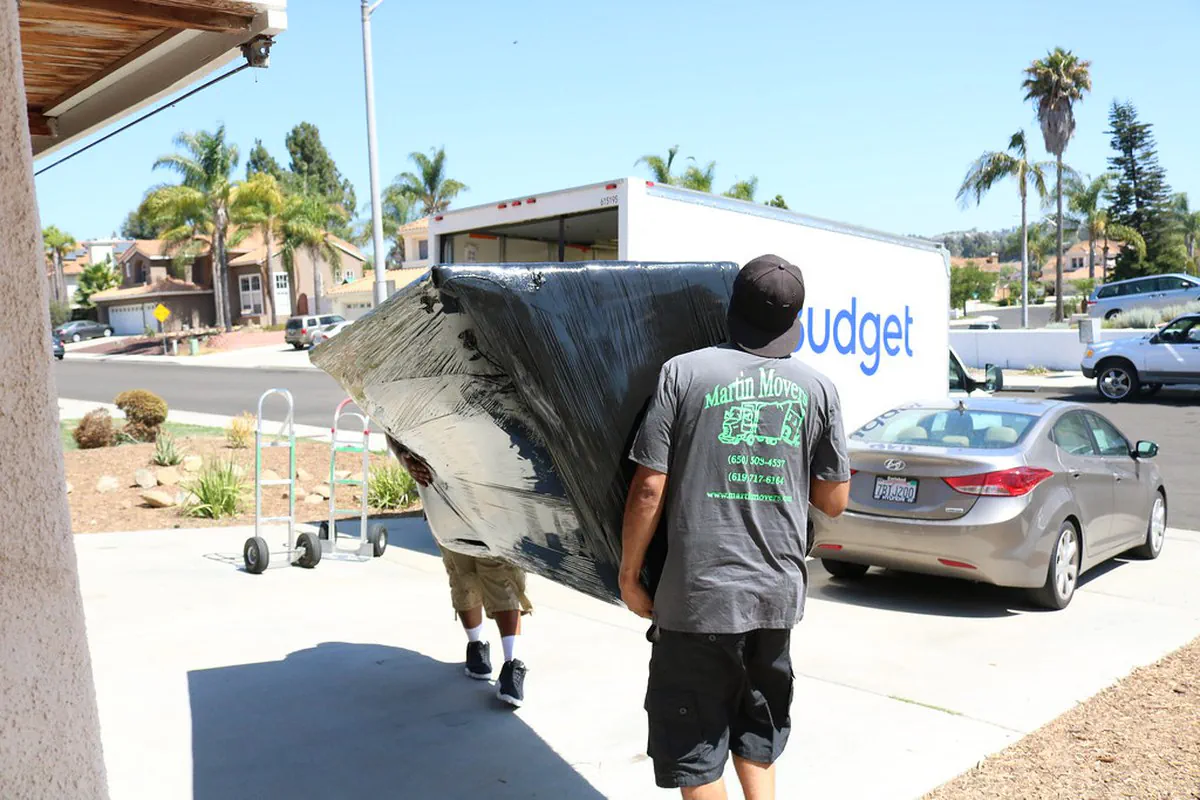 Movers Loading a Couch onto a Rental Truck
