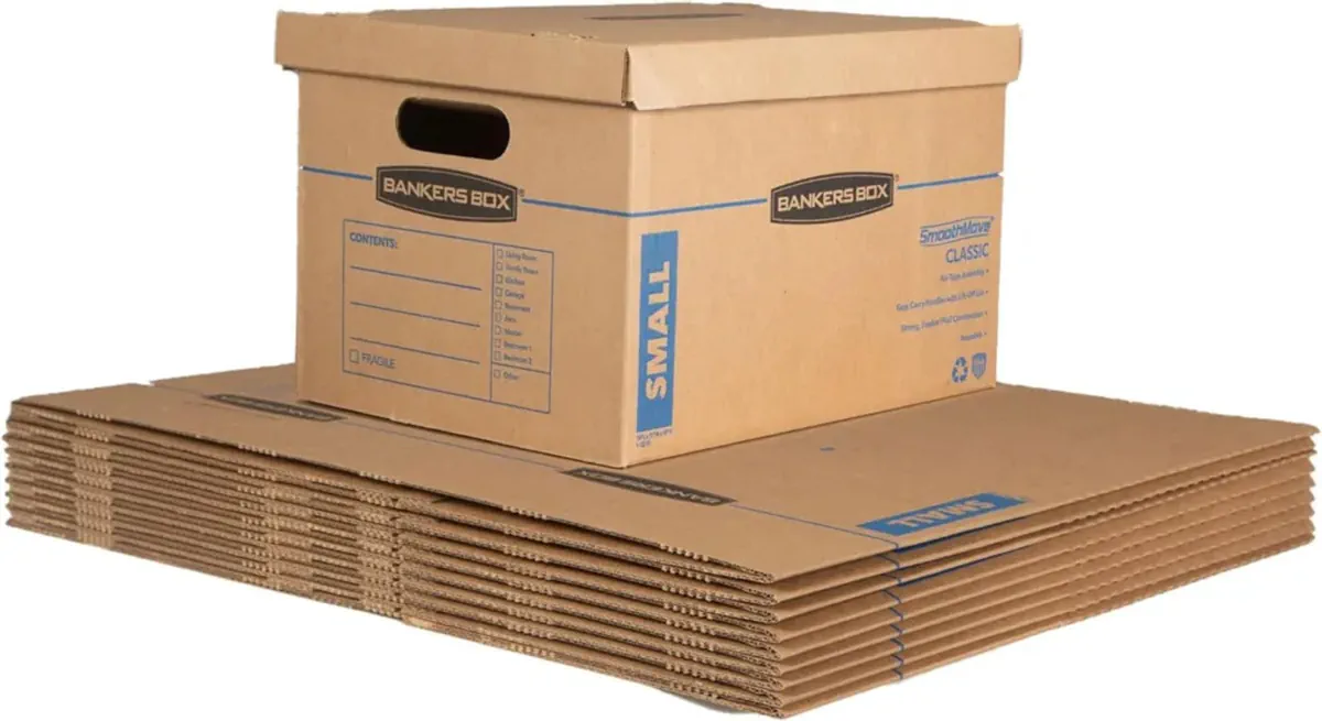 Assembled Bankers Box with lift-off lid sitting on top of a stack of flat, unassembled small moving boxes