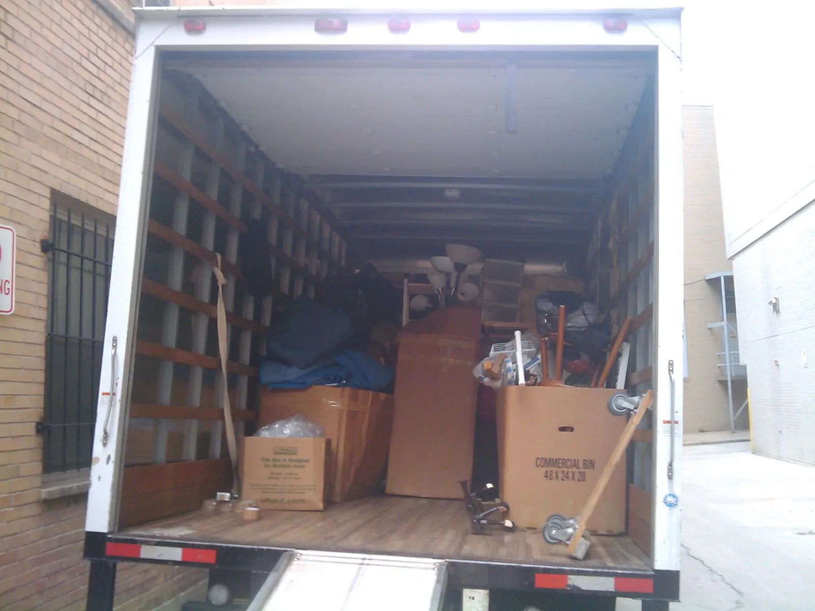 A moving truck parked outside a residence before a rental move-in inspection.
