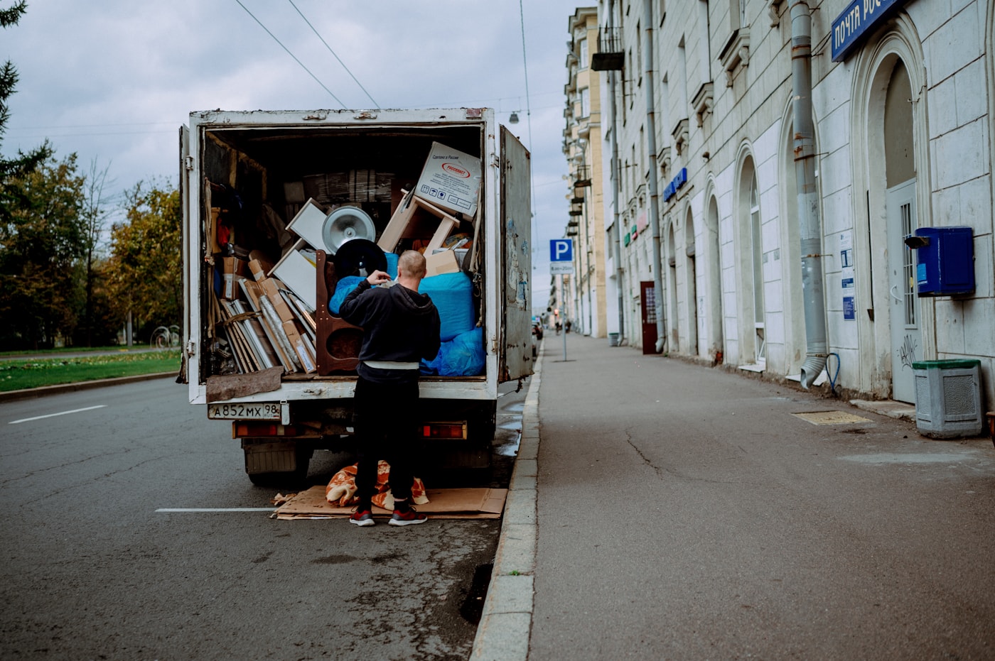 People loading household items into a moving truck
